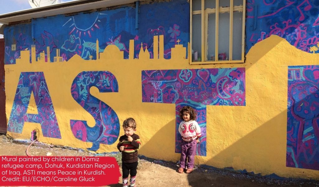 Mural painted by children in Domiz refugee camp, Dohuk, Kurdistan Region of Iraq, showing the word peace in Kurdish and designed to promote a message that Christians, Yazidis and Muslims can live peacefully together