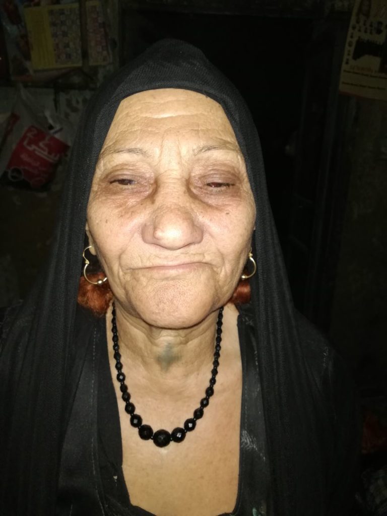 A photo of an Egyptian Copt. They are wearing a black headscarf and a black necklace. Credit: Abanob Alfy